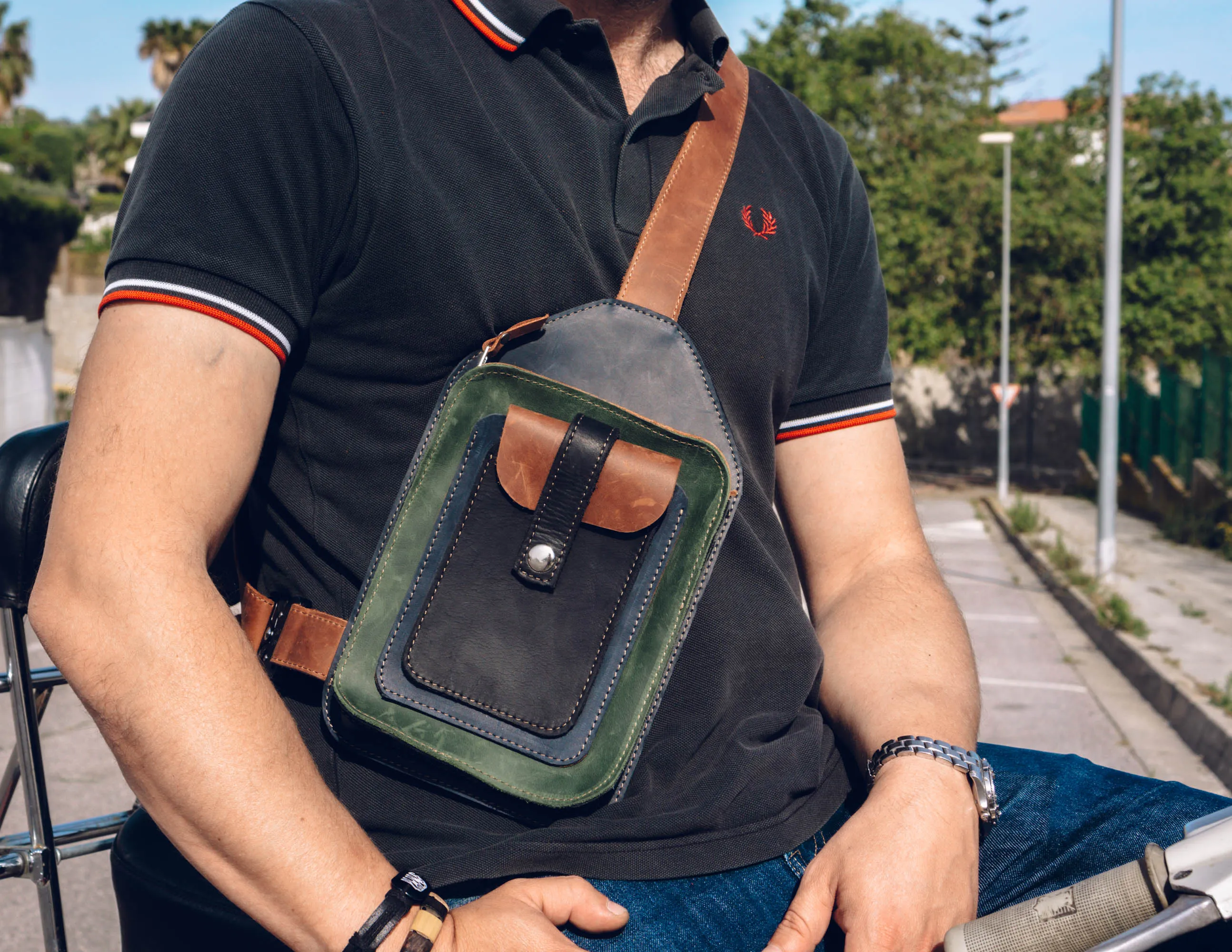 Men's crossbody bag featuring green, brown, blue, black leather and multiple pockets