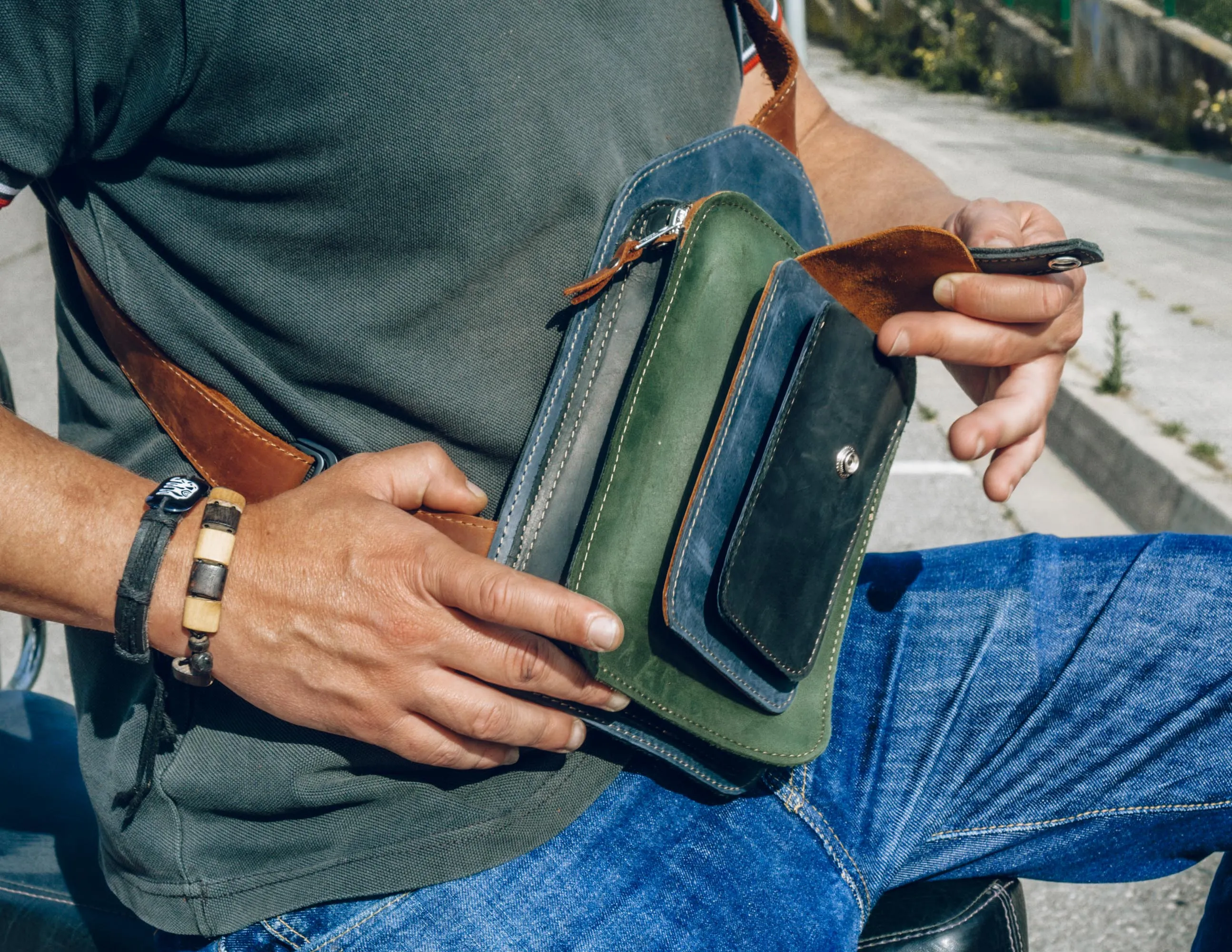 Men's crossbody bag featuring green, brown, blue, black leather and multiple pockets